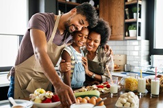 Family preparing healthy foods at the kitchen counter