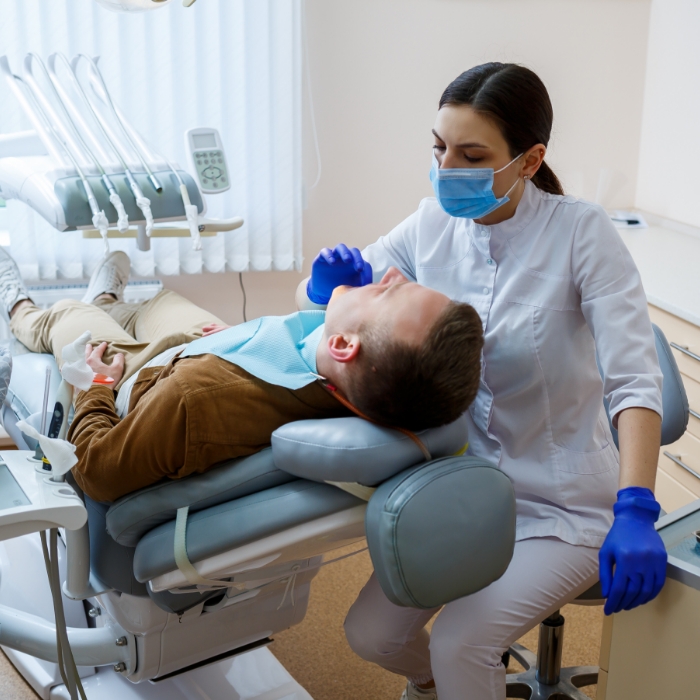 Plattsburgh dental team member showing a screen to a patient