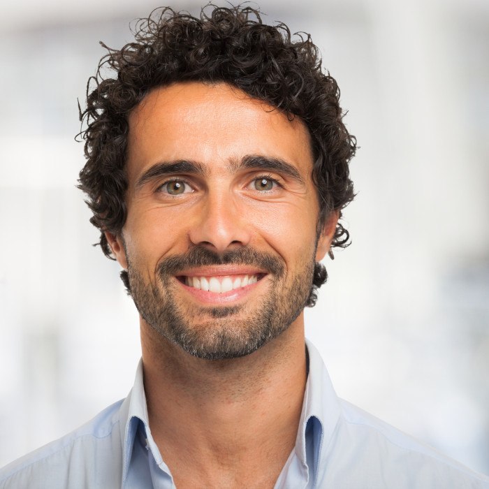 Patient in Plattsburgh smiling with their dental crowns